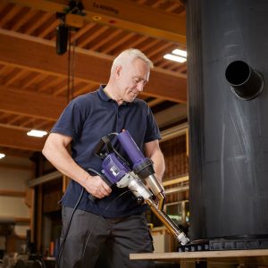 Detalhe da soldagem precisa de reservatório plástico utilizando a extrusora Weldy Booster EX3 em construção industrial.